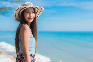 Portrait beautiful young asian woman happy smile relax around beach ocean and sea photo
