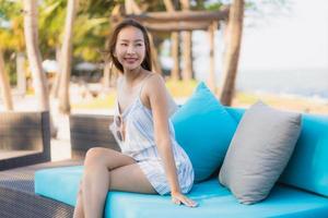 Portrait beautiful young asian woman happy smile relax around neary beach and sea photo