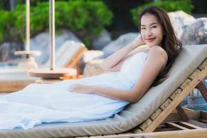 Portrait beautiful young asian woman happy smile relax around neary beach and sea photo