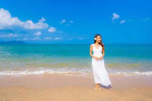 Portrait beautiful young asian woman happy smile leisure on the beach sea and ocean photo