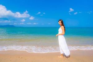 Portrait beautiful young asian woman happy smile leisure on the beach sea and ocean photo