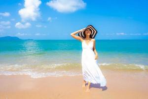 Portrait beautiful young asian woman happy smile leisure on the beach sea and ocean photo