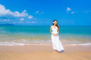 Portrait beautiful young asian woman happy smile leisure on the beach sea and ocean photo