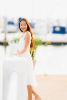 Portrait beautiful young asian woman leisure smile happy relax around yacht port photo