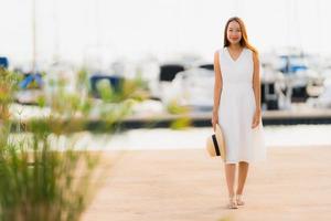 Portrait beautiful young asian woman leisure smile happy relax around yacht port photo