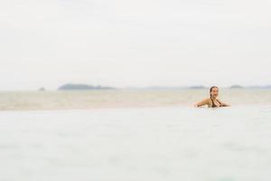 Portrait beautiful young asian woman wear bikini around swimming pool in hotel resort nearly sea ocean beach photo