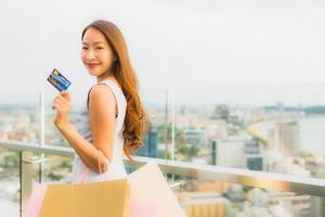 Portrait beautiful young asian woman happy and smile with shopping bag from department store photo