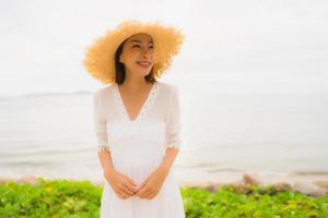 Portrait beautiful asian woman wear hat with smile happy leisure on the beach and sea in holiday vacation photo