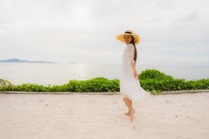 Portrait beautiful asian woman wear hat with smile happy leisure on the beach and sea in holiday vacation photo