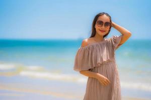 Portrait beautiful young asian woman happy smile relax on the tropical beach sea ocean photo