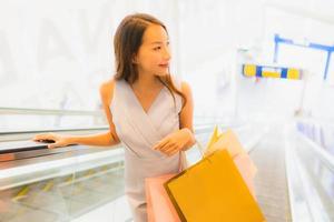 Portrait beautiful young asian woman happy and smile with shopping bag from department store photo