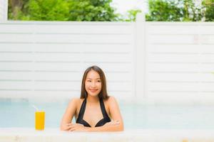 Portrait beautiful young asian woman happy smile relax around outdoor swimming pool photo