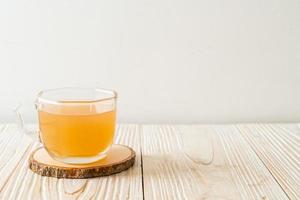 Fresh and hot ginger juice glass with ginger roots - Healthy drink style photo