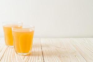 Fresh and hot ginger juice glass with ginger roots - Healthy drink style photo