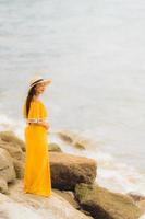 Portrait beautiful asian woman wear hat with smile happy leisure on the beach and sea in holiday vacation photo