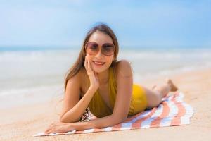 Portrait beautiful young asian woman smile happy on the beach and sea photo