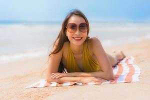 Portrait beautiful young asian woman smile happy on the beach and sea photo