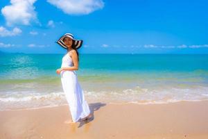 Portrait beautiful young asian woman happy smile leisure on the beach sea and ocean photo