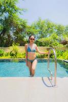 Portrait beautiful young asian woman smile happy relax and leisure in the swimming pool