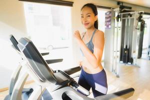 Portrait asian woman exercising and workout by running in gym photo