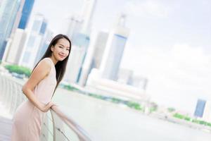 Beautiful asian woman smile and happy to travel in singapore city photo