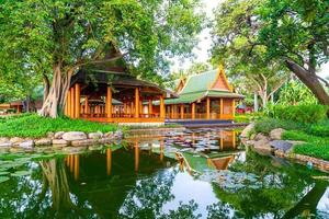 Pavilion in Thai style with lake and tree in the garden photo