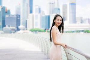 Beautiful asian woman smile and happy to travel in singapore city photo