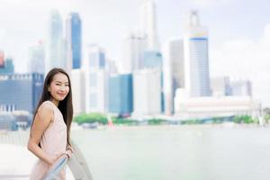 Beautiful asian woman smile and happy to travel in singapore city photo