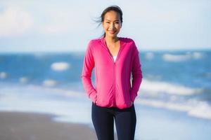 Portrait beautiful young asian woman running and exercising on the tropical outdoor nature beach sea ocean photo