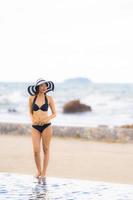 Portrait beautiful young asian woman wear bikini around swimming pool in hotel resort nearly sea ocean beach photo