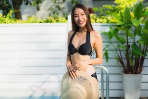 Portrait beautiful young asian woman happy smile relax around outdoor swimming pool photo