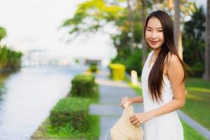 Portrait beautiful young asian woman happy and smile on the beach sea and ocean photo