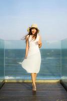 Portrait beautiful young asian woman happy and smile on the beach sea and ocean photo