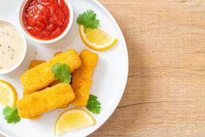 Fried fish finger sticks or french fries fish with sauce photo