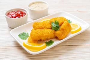 Fried fish finger sticks or french fries fish with sauce photo