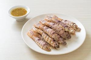 Steamed crayfish or mantis shrimps or stomatopods with spicy seafood sauce photo