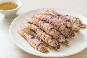 Steamed crayfish or mantis shrimps or stomatopods with spicy seafood sauce photo