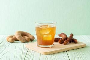 Delicious sweet drink tamarind juice and ice cube photo