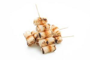 Grilled tube-shaped fish paste cake skewer isolated on white background photo