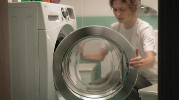A woman sorts laundry before washing video