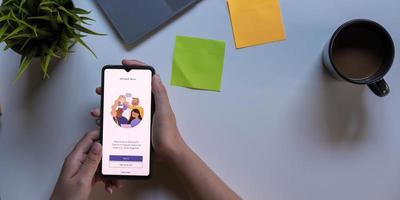 A working from home employee is downloading the Microsoft Teams social platform, ready for remote working in isolation from home photo