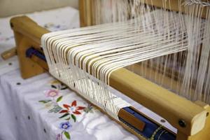 Spinning with a wooden spinning wheel photo