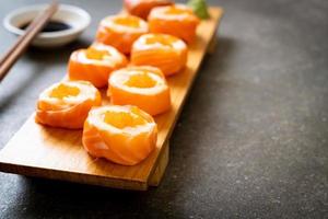 Fresh salmon sushi roll with mayonnaise and shrimp egg - Japanese food style photo