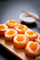 Fresh salmon sushi roll with mayonnaise and shrimp egg - Japanese food style photo