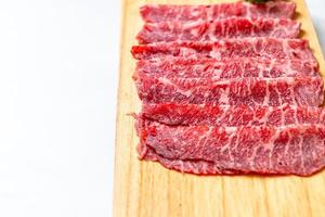 Fresh beef raw sliced with marbled texture served for Sukiyaki and Shabu or Yakiniku photo
