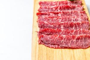 Fresh beef raw sliced with marbled texture served for Sukiyaki and Shabu or Yakiniku photo