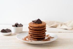 Chocolate pancake stack with chocolate powder photo