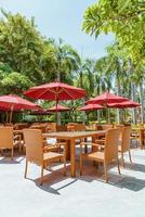 Empty outdoor patio table and chair with umbrella photo