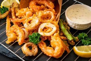 Deep-fried seafood, shrimp and squid with mix vegetables - unhealthy food style photo