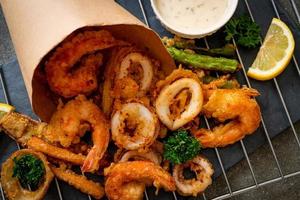 Deep-fried seafood, shrimp and squid with mix vegetables - unhealthy food style photo